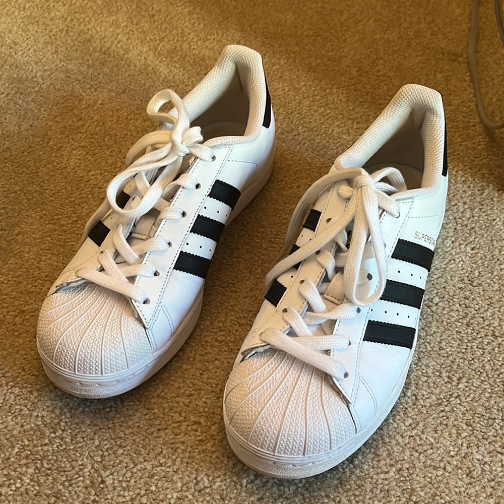 Adidas womens white with black stripes leather sneaker.